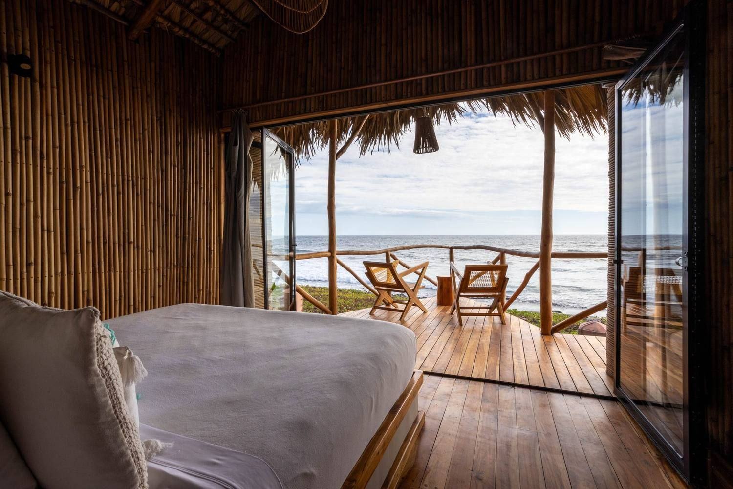 A treehouse room opening onto the sea