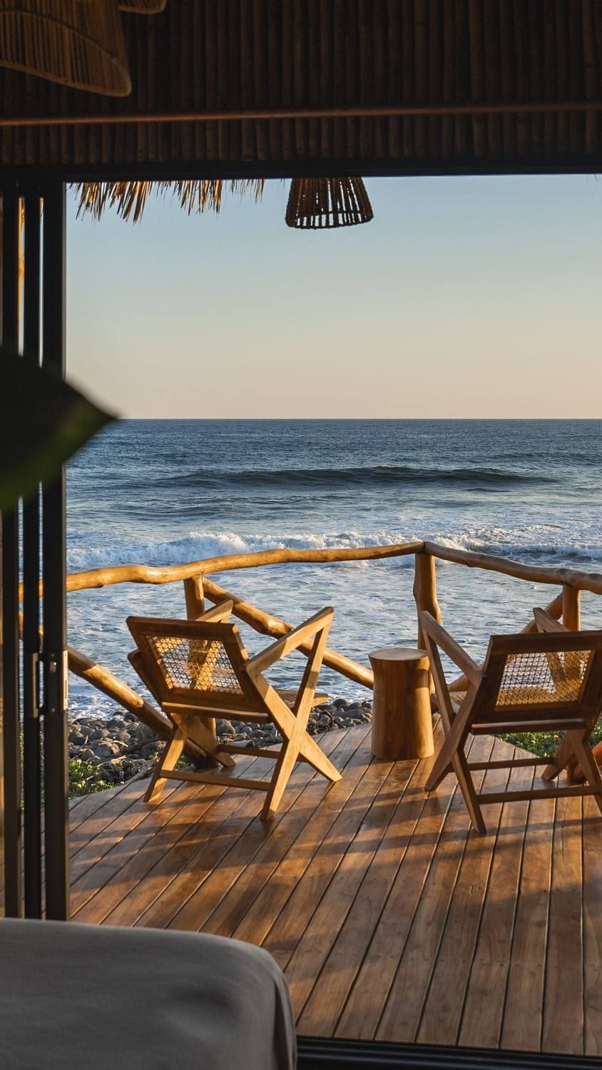 View from a treehouse bed onto the deck and the Pacific