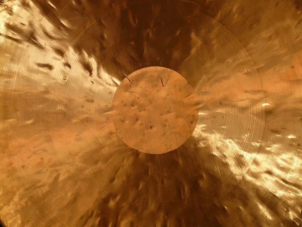 Close-up of a bronze gong catching the light