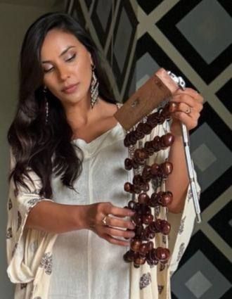 Raquel Barrantes holding a seed-pod rattle