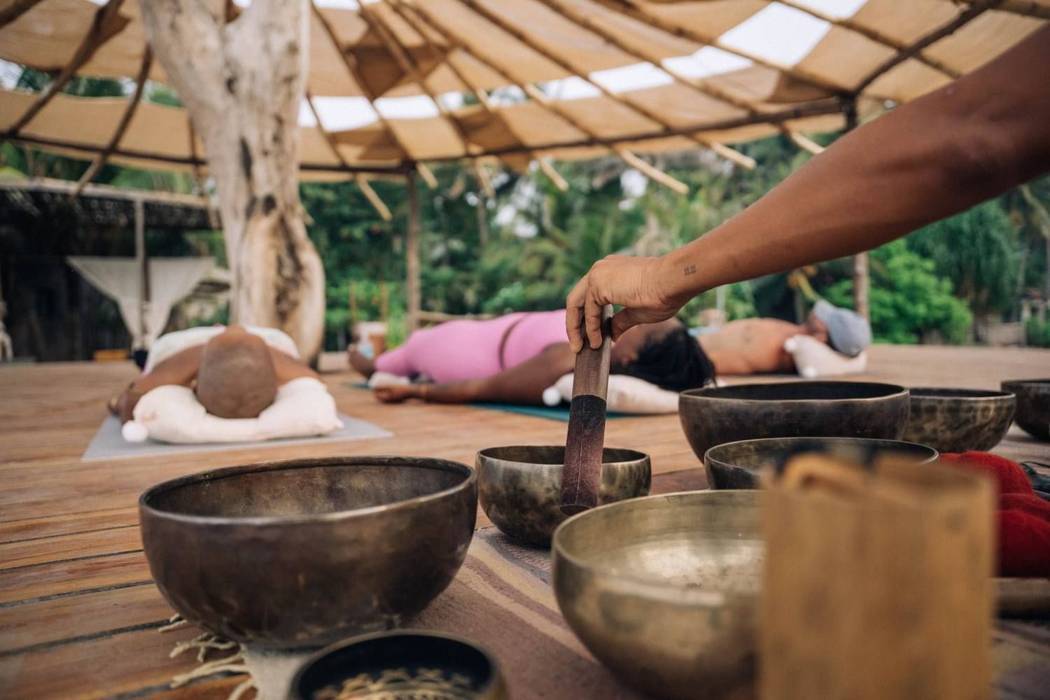 Singing bowls being played during a sound bath