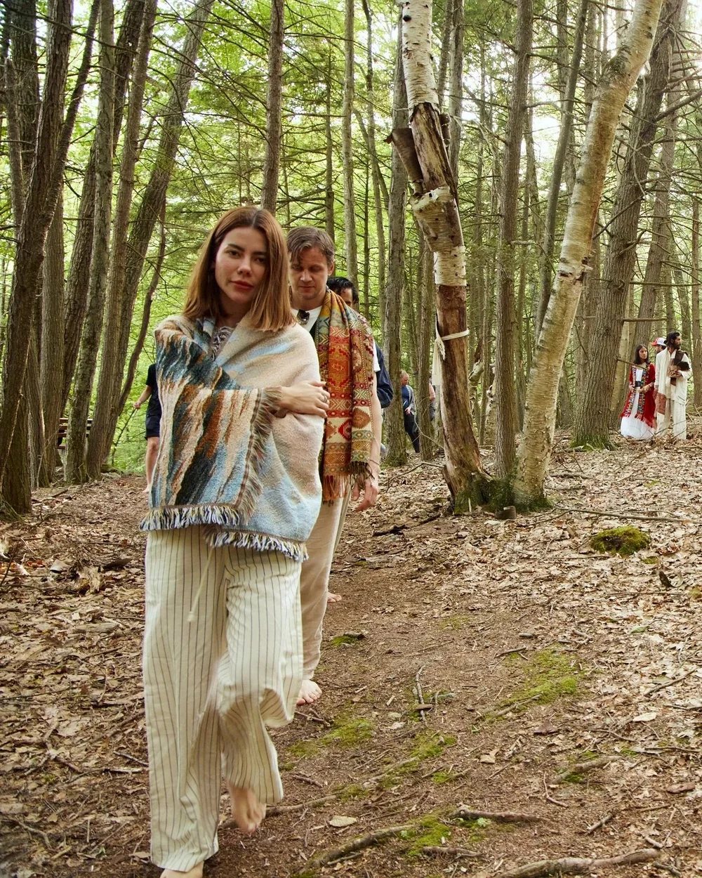 Guests walking barefoot on a forest trail at The Thyme