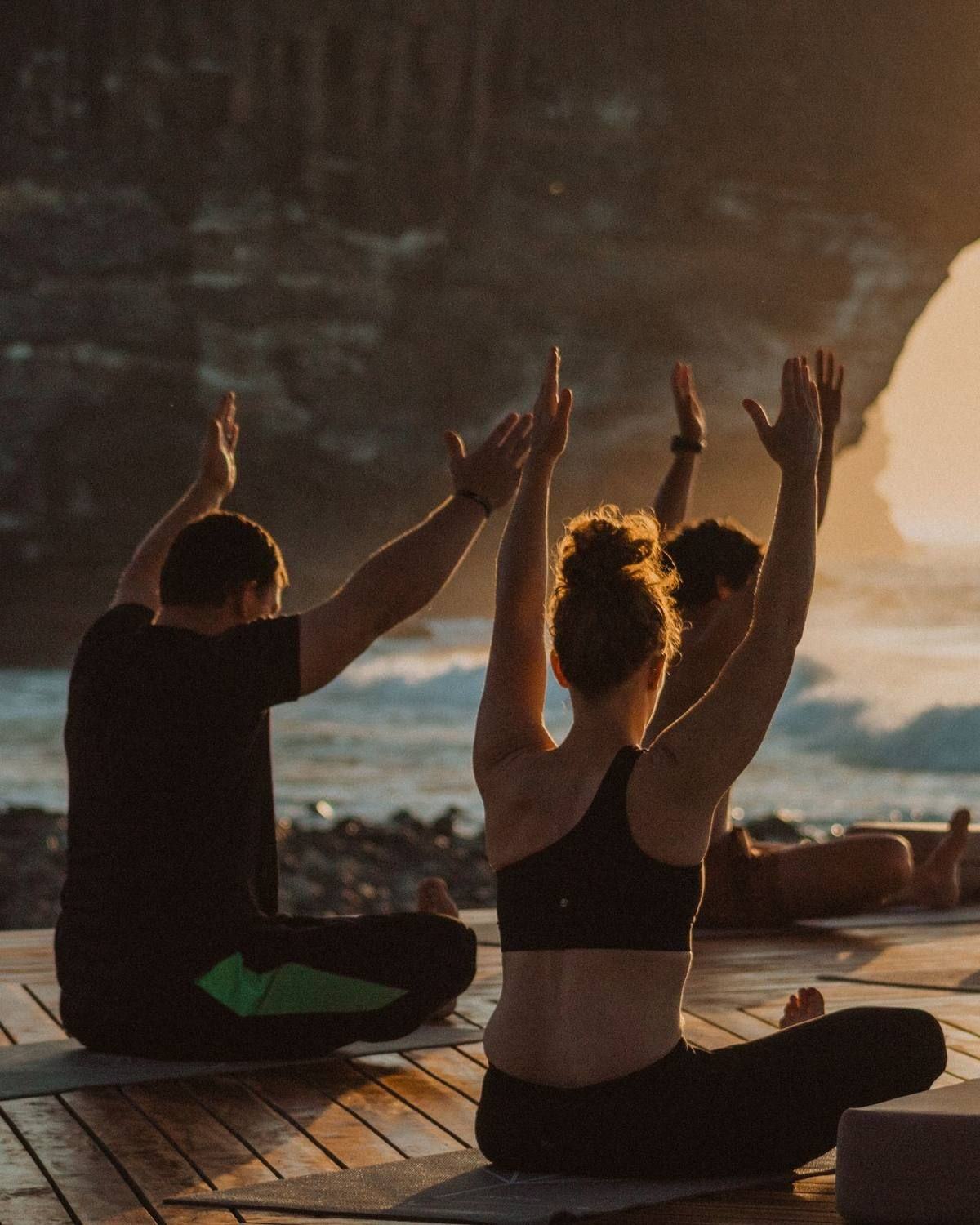 Guests stretching together as the sun goes down